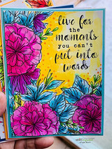 Vivid card with magenta and blue flowers framing 'live for the moments you can't put into words.'