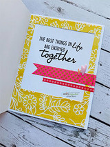 Mustard floral card with a white panel, the sentiment 'THE BEST THINGS IN life ARE ENJOYED together' over a pink banner strip and a small bloom.