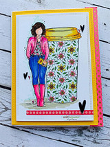 Yellow and pink layered card, the girl in a pink jacket and blue jeans beside a flower-patterned travel cup, hand-drawn hearts and a dotted border.