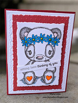 Card with the softly colored panda in a blue flower crown, stamped 'sitting here thinking of you.'