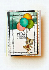 Card with the balloon kitty on a dark distressed panel, 'MEOW is the time to celebrate.'