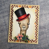 The elegant llama in a black top hat with succulents on a woodgrain frame card.