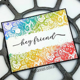 Handmade card featuring the delicate all-over lace pattern filling an A2 background, in rainbow ombre, stamped with 'hey friend'.