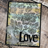 Card of the tapestry background in soft tones with a fabric bow and "Love."