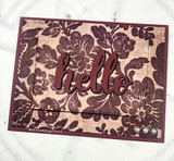Warm card of the tapestry background stamped "hello."