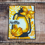 Card on wood with a yellow floral background, a lantern die layered with two golden butterflies from this set, 'Hello' banner strip.