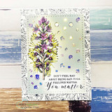 Card with the wildflower colored purple and yellow on a white panel with clear gem accents over driftwood-blue paper.