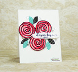 Three red swirled lollipops with leaves on a clean white card, reading 'it's your day.'