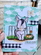Card of the pony against a cloudy blue sky with gingham and a "Hello Cutie" sentiment.