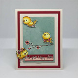 Card with yellow birds perched on a branch on a sage panel over deep red, 'find your happy place.'