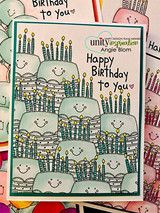 Stack of smiley cakes in green, 'Happy Birthday to you.'