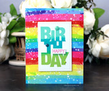 Oversized bold block-letter greeting words hand-stamped on a card and lettered "Birthday."