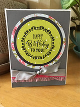 Gray card with a yellow layered circle wreath, 'HAPPY Birthday TO YOU!'
