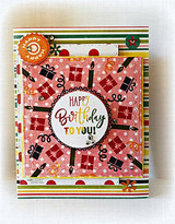 Red card with a present-and-icon wreath, 'HAPPY Birthday TO YOU!'