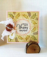 Golden card with a leafy wreath, 'Wishing you a Happy Birthday.'