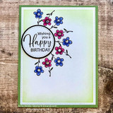 Green card with a blue floral wreath, 'Wishing you a Happy Birthday.'