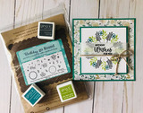 Packaged stamp set beside a green card with a leafy wreath, 'Birthday WISHES.'