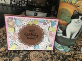 Card of the mug border in pastels around "Happy Birthday."