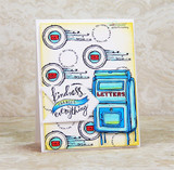 Card with a blue mailbox and scattered postmarks, 'kindness changes everything.'