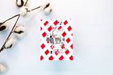 Red buffalo-check mini card with the tiny animal stack, cotton stems behind.