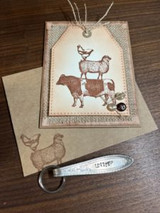 Tag with the stack stamped in sepia on an envelope with a Unity keychain.