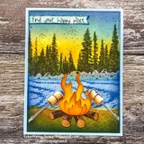 Card layering a lakeside pine forest and a marshmallow-roasting campfire in blues, greens and gold, topped with a small banner reading Find your happy place.