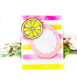 Pink and yellow striped card with a scalloped circle frame and a single lemon slice, photographed with pale roses.