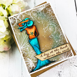 Shell border stamped in white over a sandy background with a teal mermaid, 'A day at the beach restores the soul.'