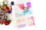 Rainbow watercolor card with the softly stamped dahlia corner spray.