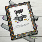 Big-eyed bat on a striped Halloween card, 'HALLOWEEN GREETINGS'.