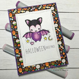 Purple-bellied bat on a candy-print Halloween card, 'HALLOWEEN GREETINGS'.
