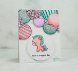 Card with the balloon border background around a little unicorn and a 'Have a magical day' sample sentiment.