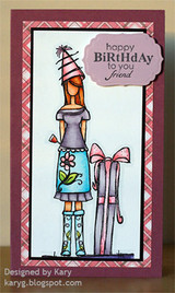 Sample card: Maggie in lavender and aqua with a pink-bowed gift inside a raspberry plaid frame