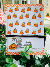 Candy-corn pattern with a mummy and pumpkin, 'happy Halloween.'