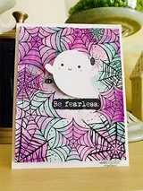 Pink and green webbed card with a happy little ghost. Be fearless.