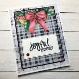Black-and-white plaid card using Rustic Winter Wishes paper with a red bow and 'joyful greetings'