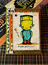 Card on orange and black Halloween plaid with crumpled kraft; Frank stands in a teal shirt above 'frank you very much.'