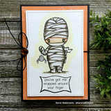 Orange and black card with greenery: the mummy in gray beside “you've got me wrapped around your finger.”