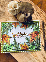 Card framing an open center with the fall-colored leaf border on a scalloped panel, stamped 'Gratitude.'