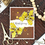 Card with the leaf border colored in golden oak leaves and acorns over a rich brown panel, stamped 'Happy Thanksgiving.'