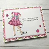Card with the girl coloured in pink with green and red lights on a floral border, finished with a little Christmas magic sentiment from another set.