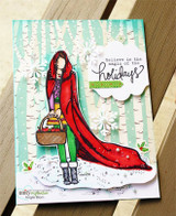 Card with the girl coloured in a red coat and green boots against a white birch forest on a mint striped background, with the believe in the magic of the holidays sentiment.