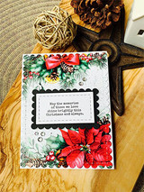 Card with red poinsettias on a tag, 'May the memories of those we love shine brightly this Christmas.'