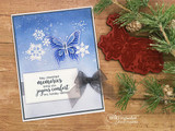 Card with a blue butterfly and snowflakes, 'May cherished memories bring you joyous comfort.'