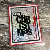 Red-framed card with a silver glitter background and the black 'MERRY CHRISTMAS' block letters.