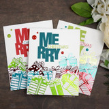 Trio of cards showing 'MERRY' block letters above stamped stacked gift boxes.