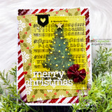 Card using the paper pack: a decorated Christmas tree on layered plaid and script paper with 'merry christmas.'