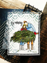 Navy and patterned card with the couple carrying the tree, 'Be merry'