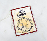 Card with a deer and wreath with a crescent moon above 'Joy to the World'.