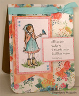 Card with the girl in a pink cape and aqua dress on a pink panel over coral floral paper, with the Emerson sentiment and an aqua bow.